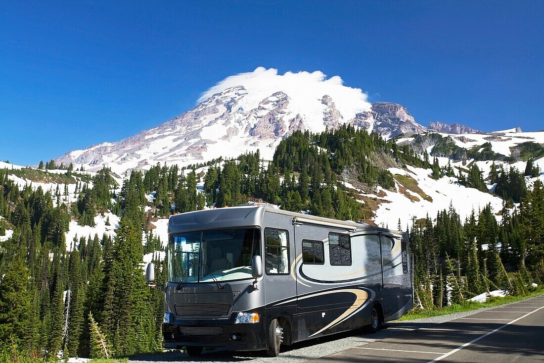 Rv Parked On The Side Of The Road With Mountain In The Background