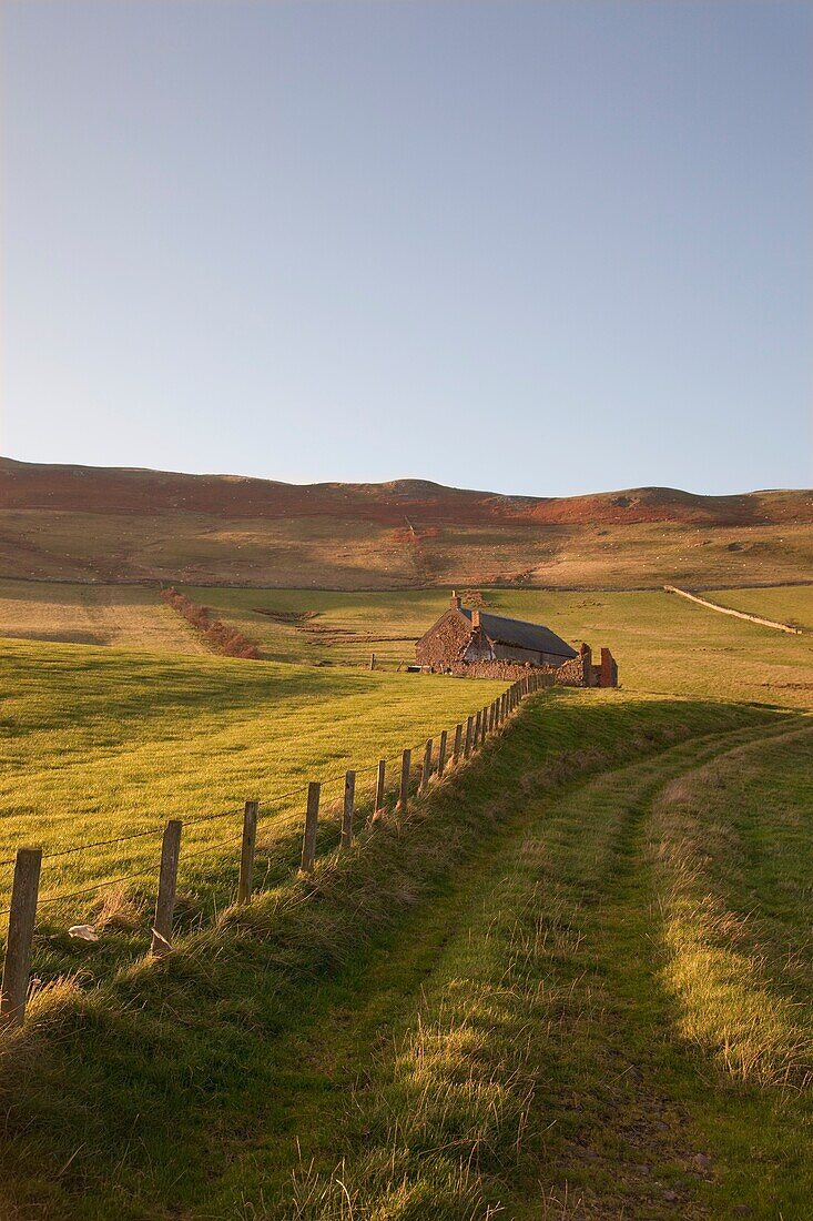 Northumberland, England; A Farm Structure And A Fence Around A Field