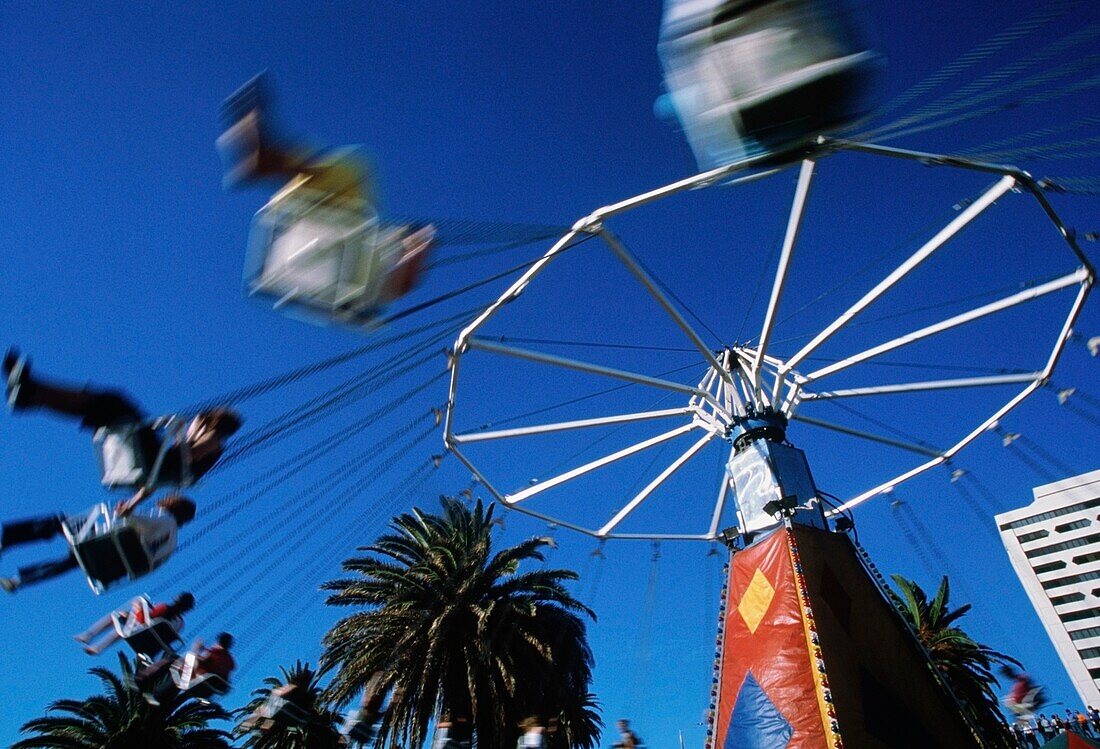 People On A Flying Swings Ride At A Funfair, Blurred Motion