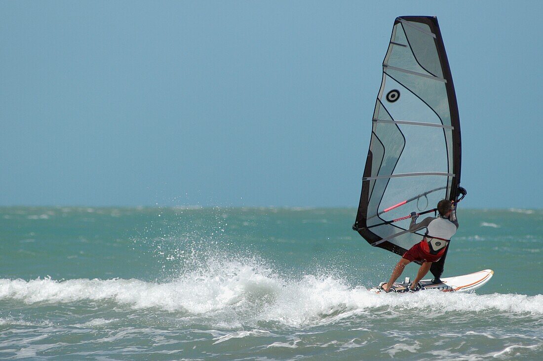 Man Windsurfing On Sea