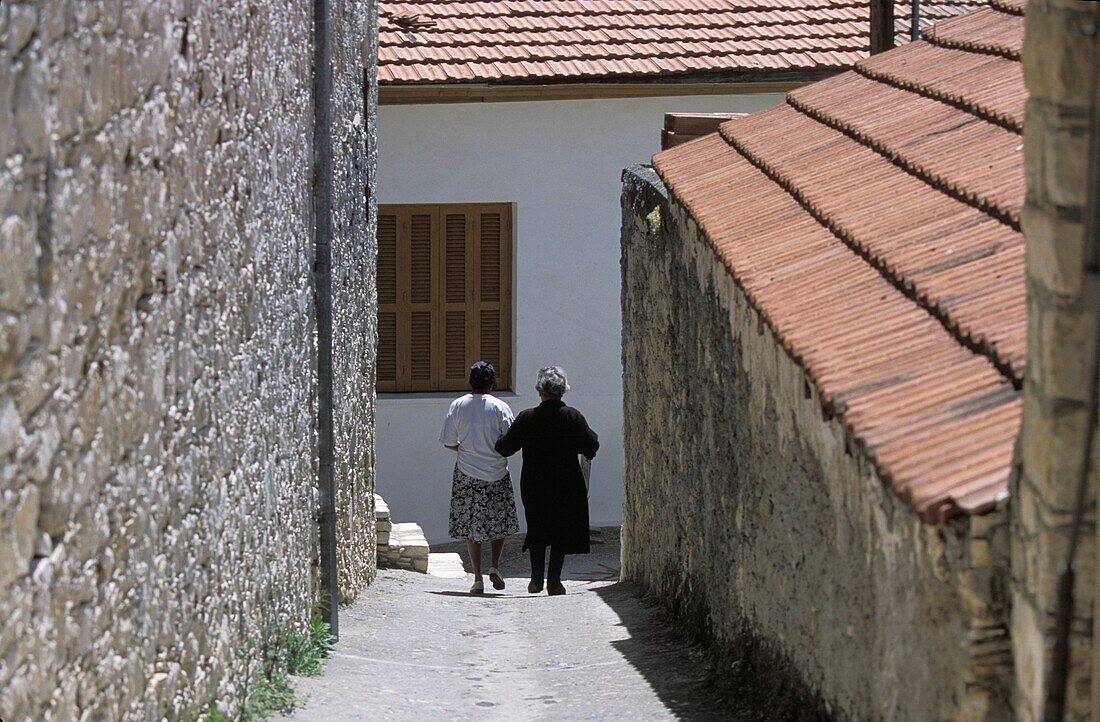 Two Senior Women Walking Down Narrow Lane