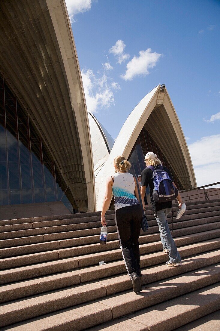 Two Young Women Ascending Stairs Outside Sydney Opera House