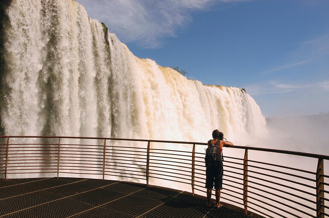 Woman On Viewing Platform Looking At Iguacu Falls
