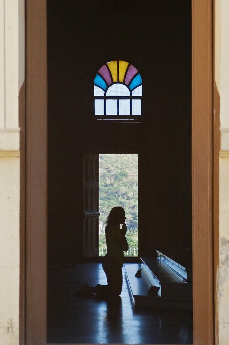 A Person Praying In The El Cobre Church.