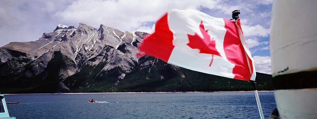 Canadian Flag On Boat On Lake Minnewanka