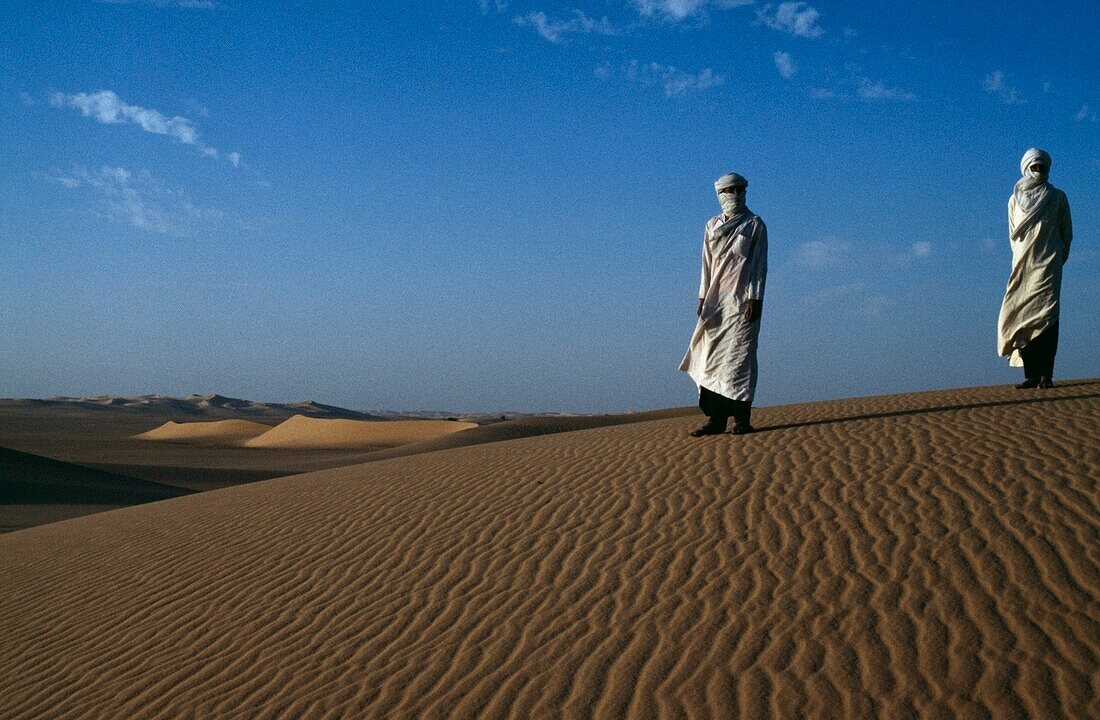 Men Standing On Sand Dunes