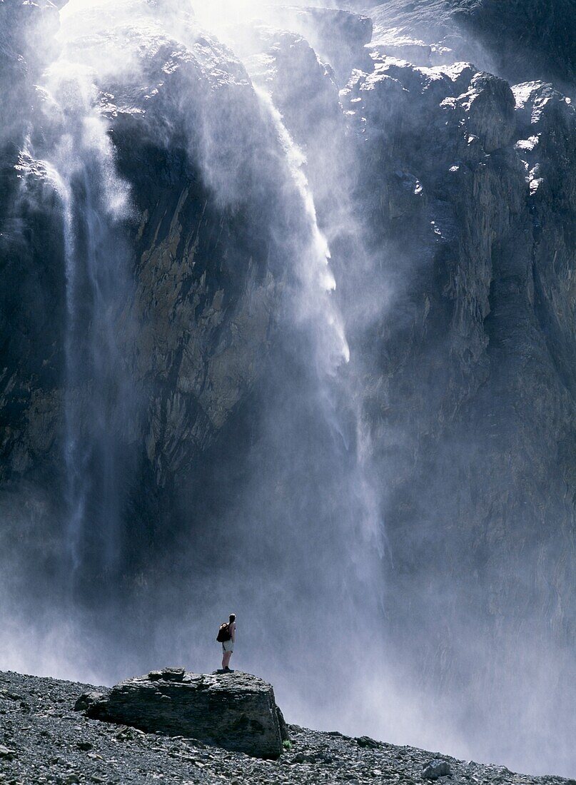 Walker Beneath Waterfall In The Cirque De Gavarnie