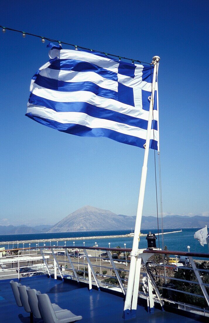 Greek Flag On A Ferry Leaving Port