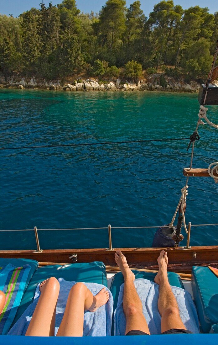 Couple Lying On Deck Of Yacht Sailing Near The Island Lefkas.