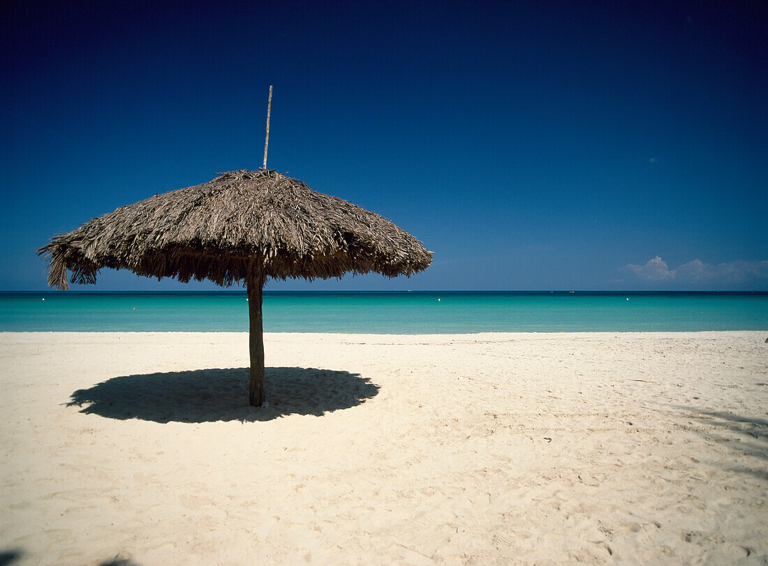 Straw Umbrella On White Sand Seven Mile Beach