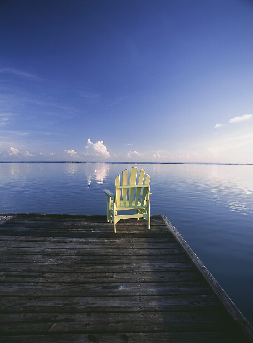 Chair On End Of Pier At Dawn