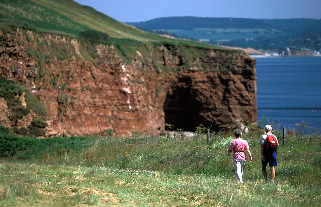 Elderly Couple Walking Along Coastal Path