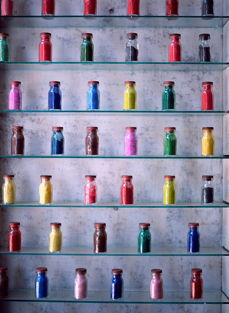 Morocco, Small Glass Bottles Containing Dyes Lined Up On Shelves; Marrakech