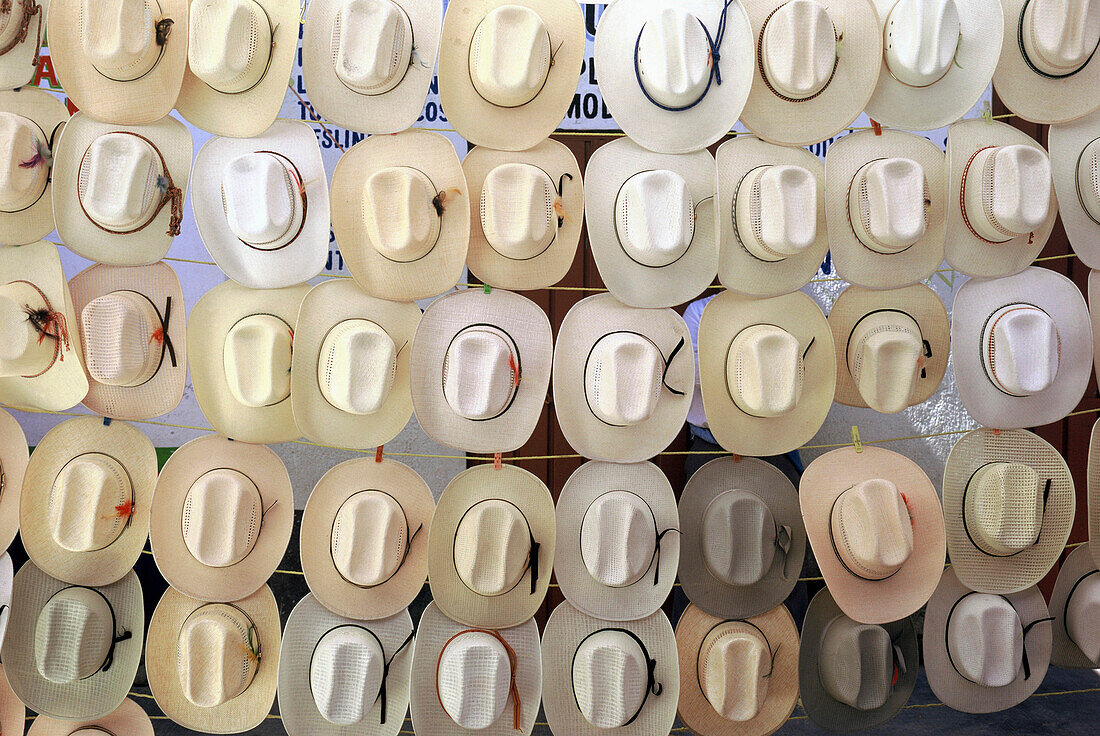 Large Group Of Hats Hanging In A Market