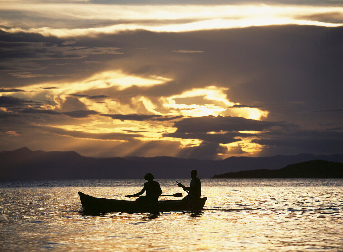 Fishermen Going Past The Island Of Domwe At Dusk