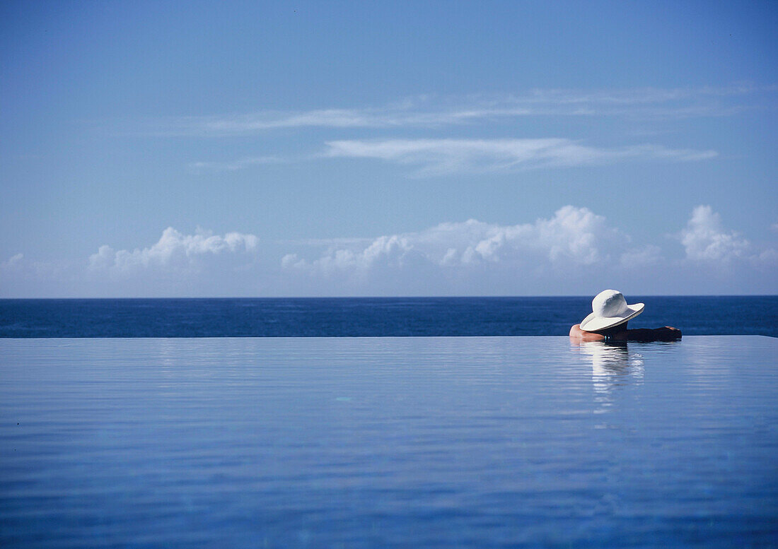 Woman Wading In An Infinity Pool