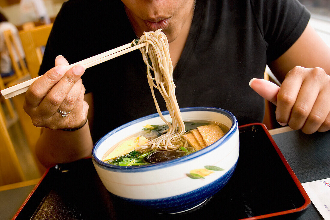 Woman Eating Noodles With Chopsticks