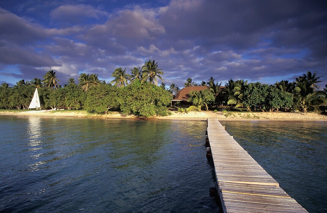 Wooden Jetty Leading Towards Tropical Beach