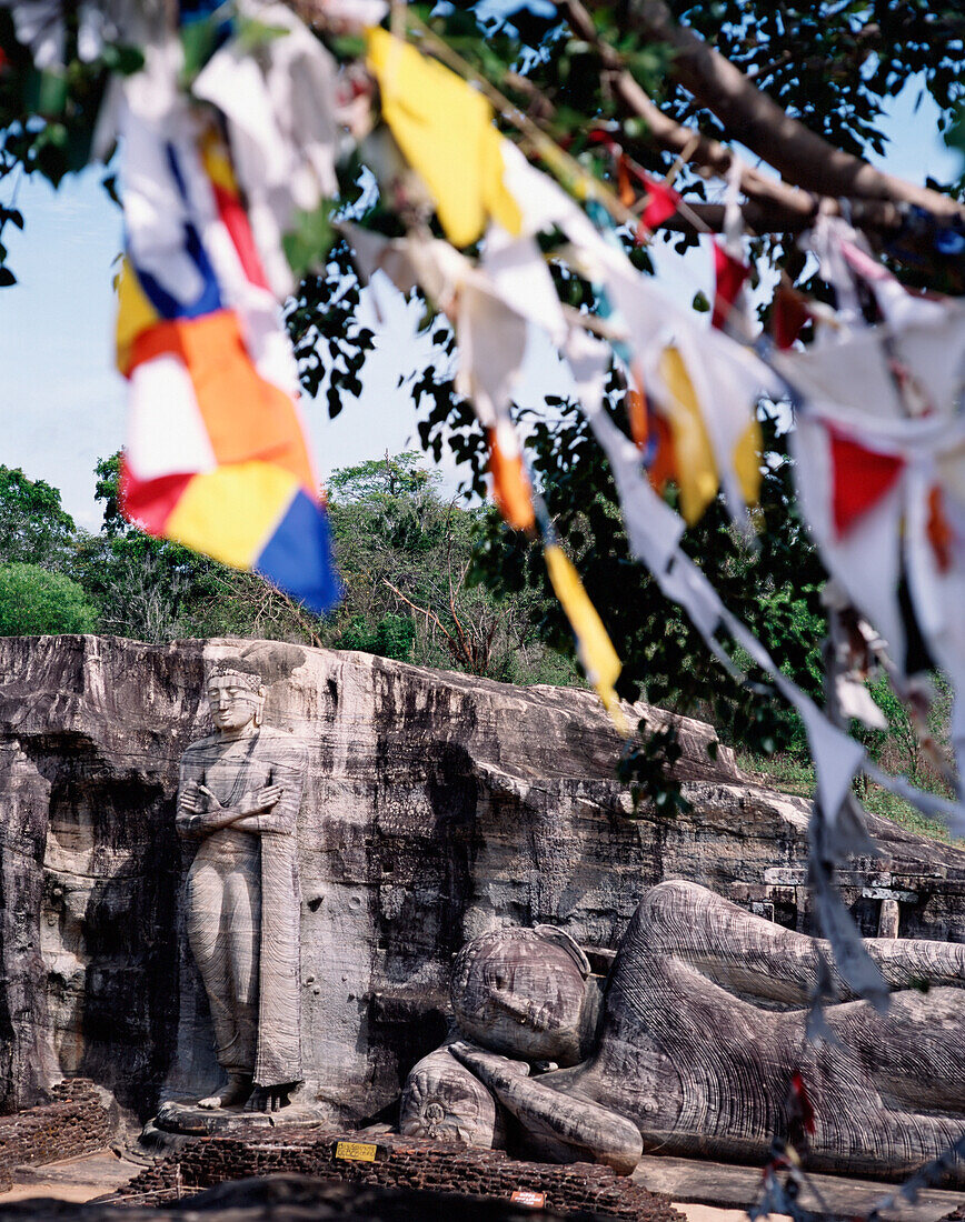 Standing And Reclining Buddha With Prayer Flags.