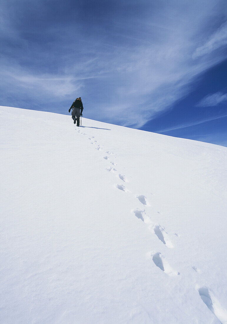 Climber Walking Up Snowy Slope In The Sierra Nevada Mountains