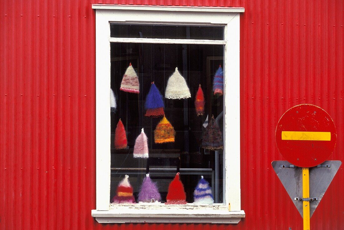 Hats Hanging In Shop Window Of Red Building, Close Up