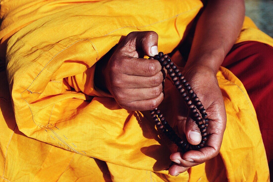 Monk Holding Prayer Beads