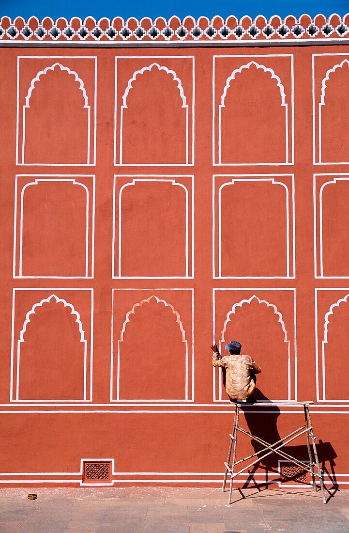 Man Repainting City Palace