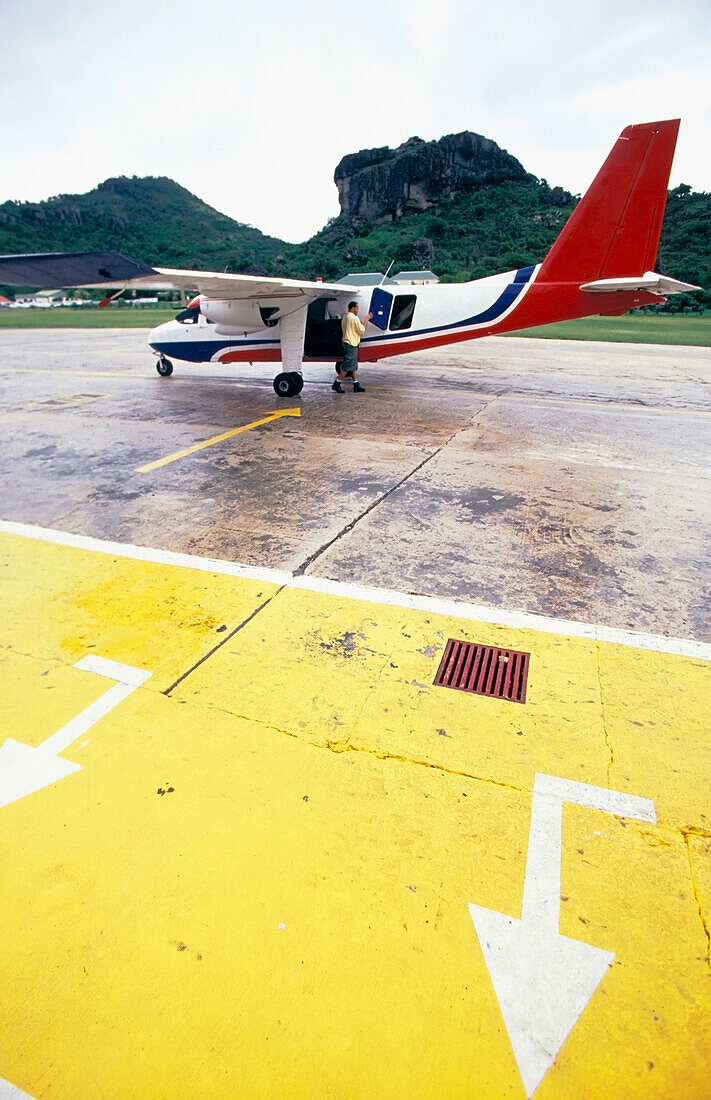 Pilot And Small Plane At The Airport On The Runway