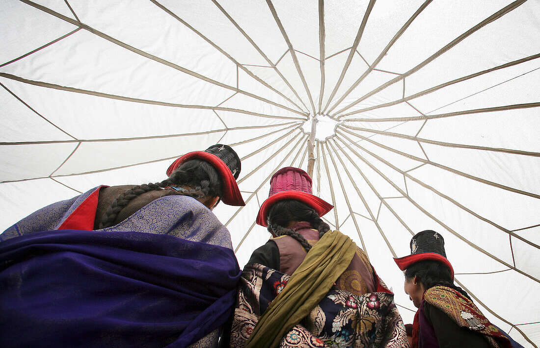 Ladakhi Woman In Traditional Dress And Hats Dancing Under A Traditional Tent