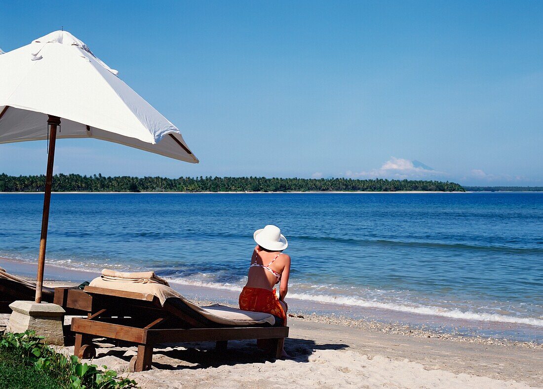 Woman Sitting Alone On Beach