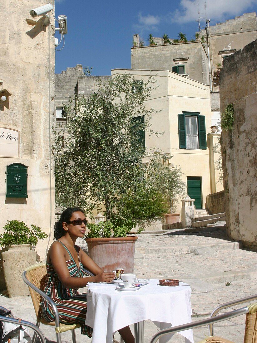 Woman Sitting In Alfresco Cafe