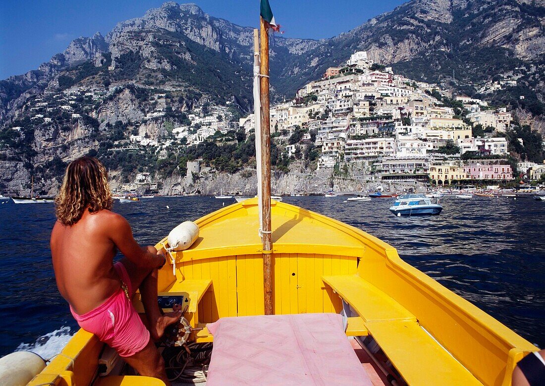 Man Riding A Boat Towards Coastline