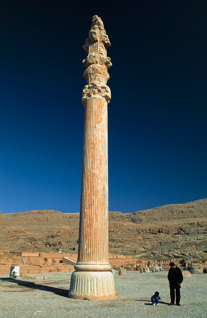 Tourists Standing Beside A Column