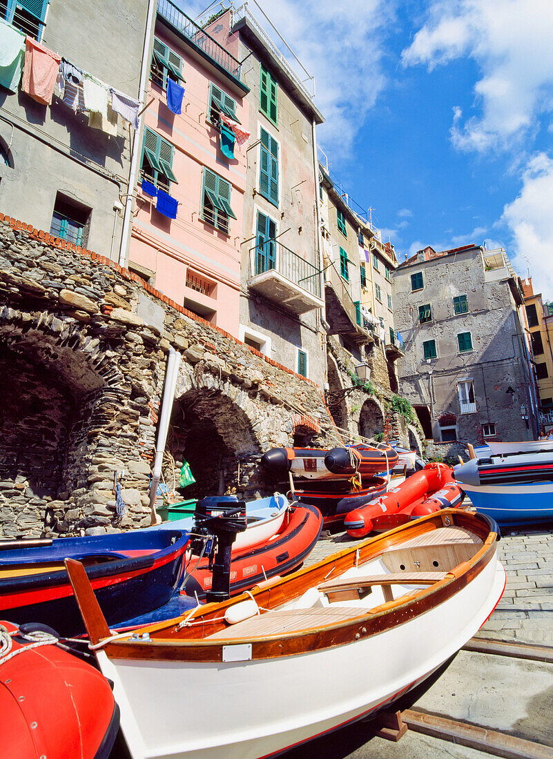 The Village Of Riomaggiore With Row Boats In The Foreground.