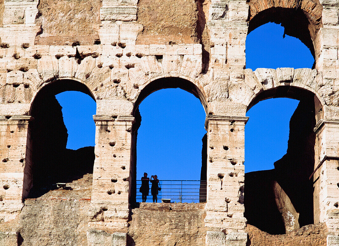 Colloseum With Silhouette Of Two People