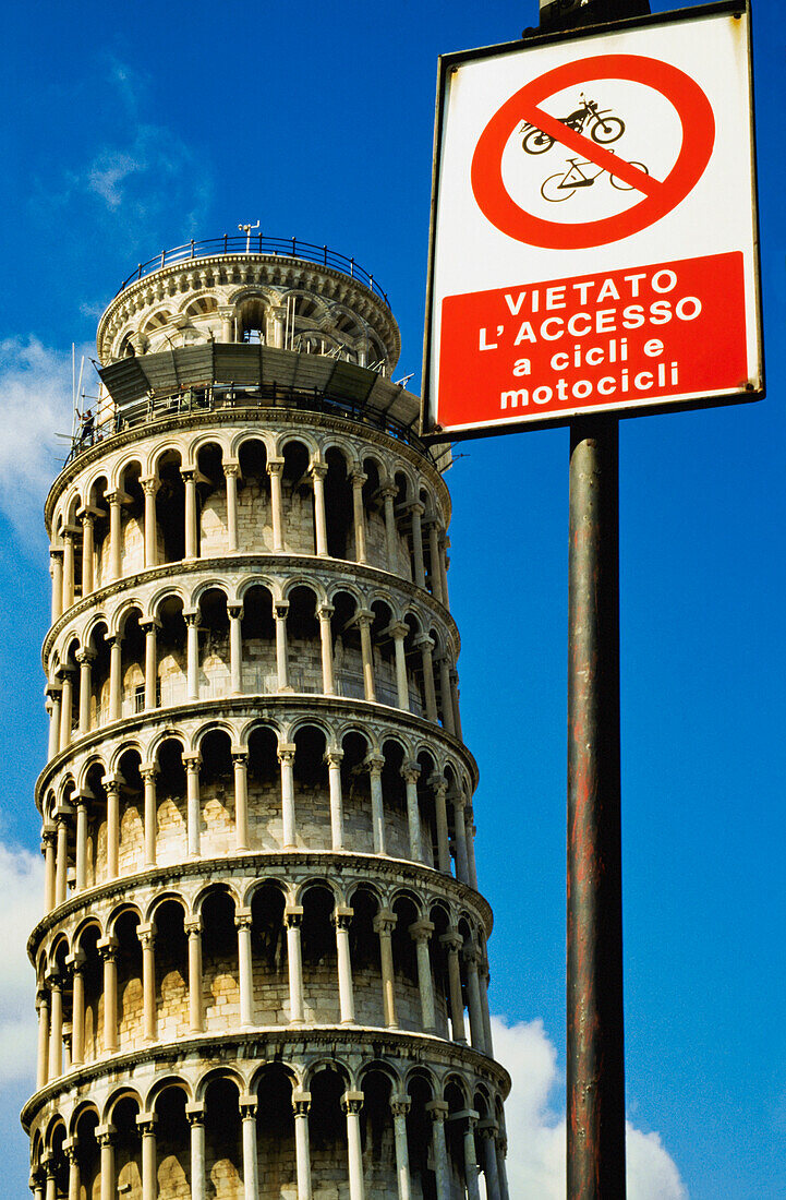 Road Sign In Front Of Leaning Tower Of Pisa