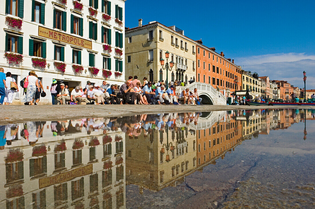 Tourists And Locals Enjoying The Sun In Venice.