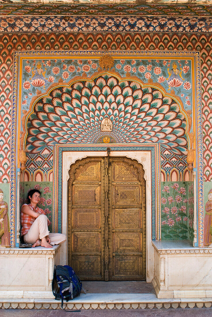 Woman With Backpack Sitting In Decorated Entrance Area Of Door Of The City Palace