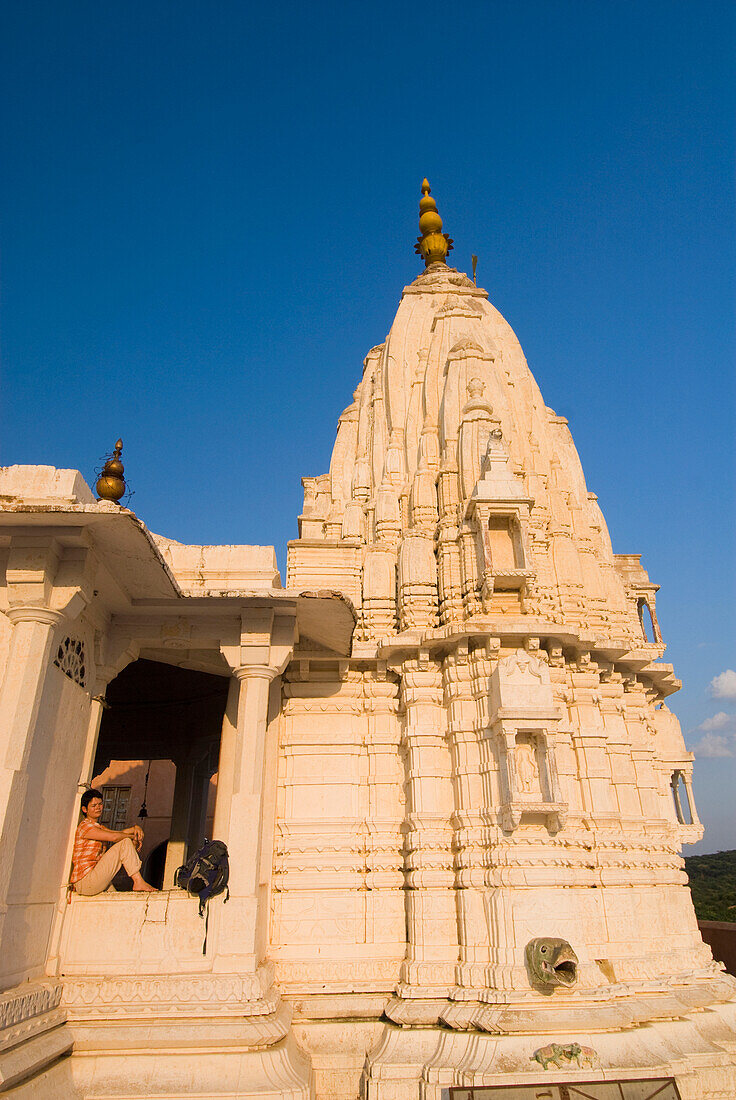 Woman Sitting In Small Temple