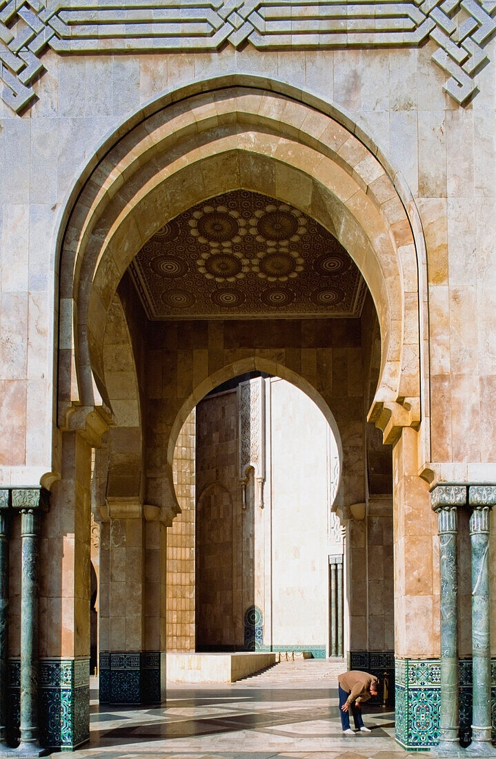 Building with marble walls showing decorative facade and archways