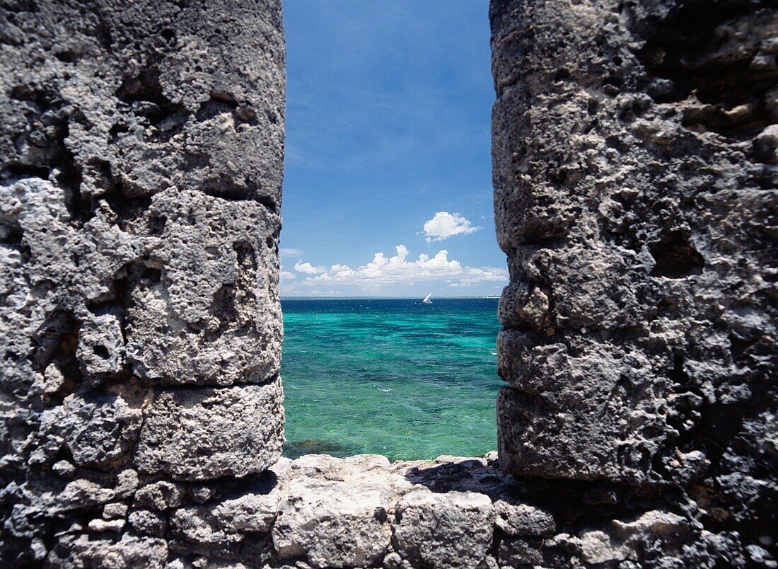 Looking Through Slit In The Walls Of The Fort Of Sao Sebastiao To Dhow Sailing Past