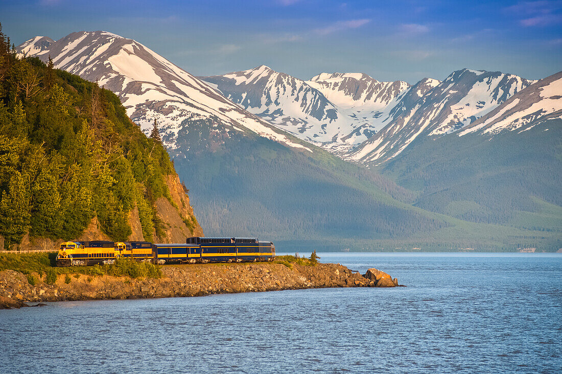 An Alaska Railroad Passenger Train Rounds A Corner Along Turnagain Arm Near Bird Creek, Southcentral Alaska, Summer