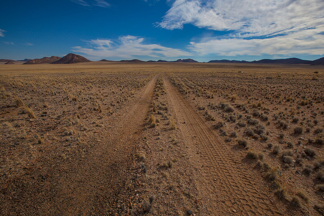 Tire tracks in the dirt on a desert road; Klein-aus vista namibia