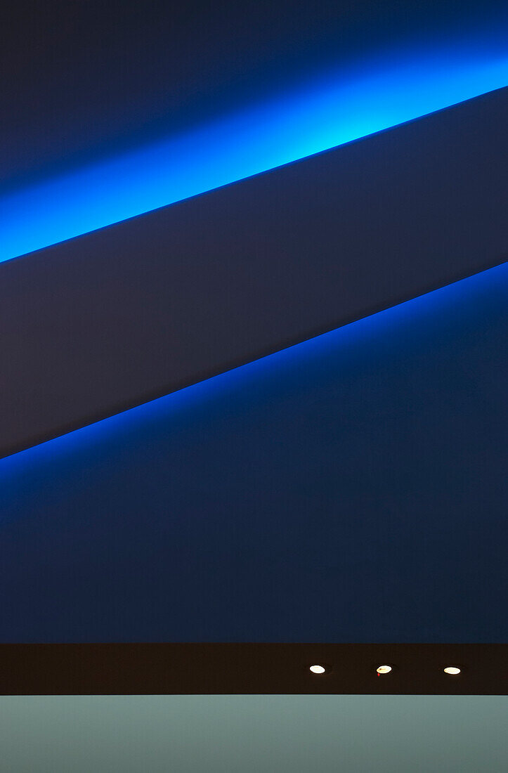 Lights along a blue wall in the virgin atlantic lounge, heathrow airport; London, england