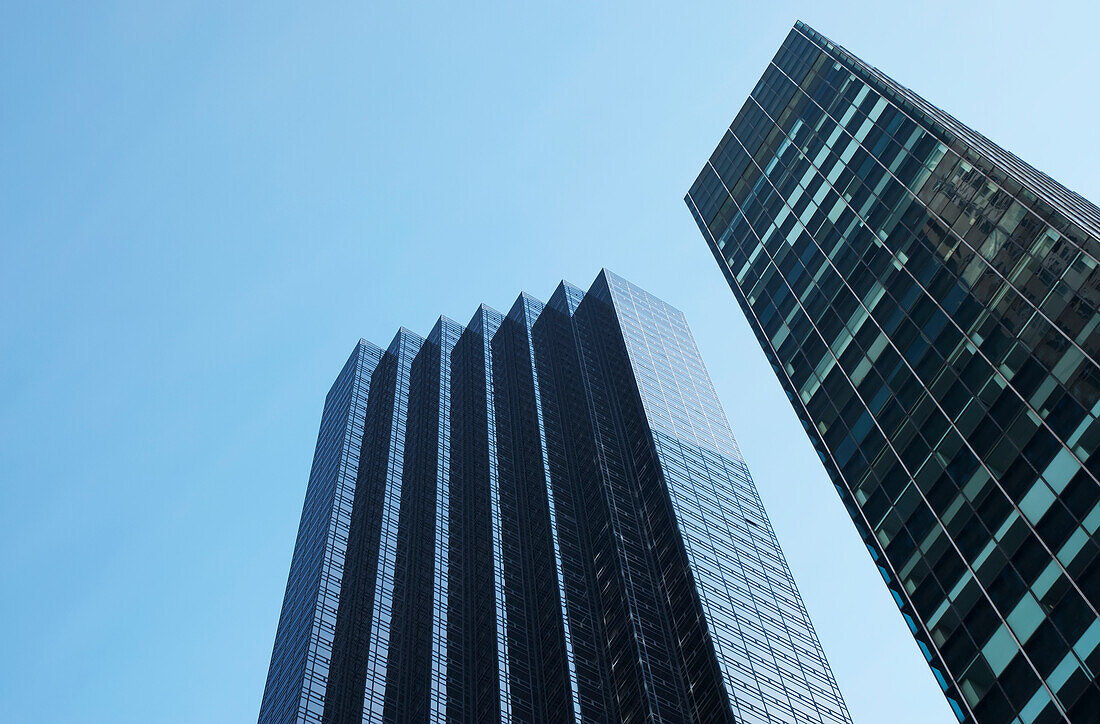 Low angle view of two skyscrapers against a blue sky with a facade like steps; New york city, new york, united states of america