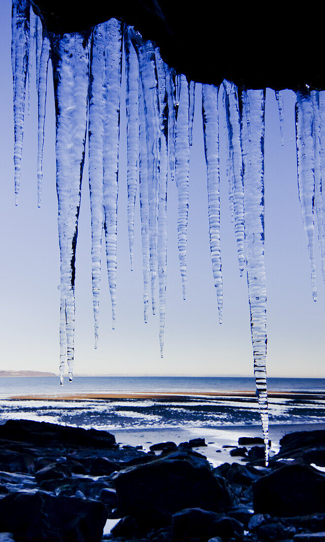 Icicles Hanging Down A Cliff Face; United Kingdom