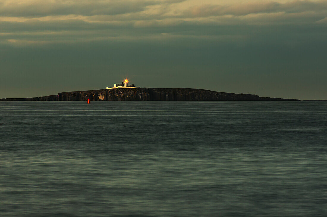 A Beacon Light Shines Under Storm Clouds On An Inner Farne Island; Northumberland, England