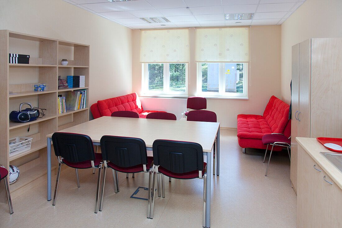 A school staff room or teacher's room, a rest room with sofa and chairs. 