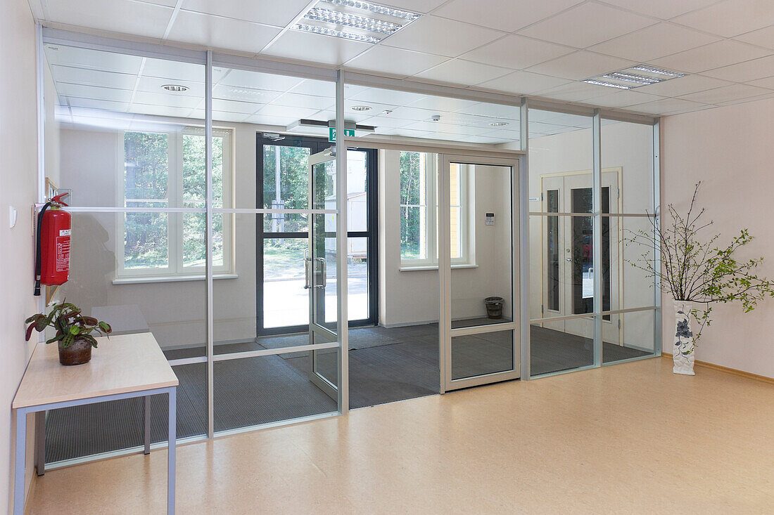 An empty modern school, wide glass doors and entrance hall. 