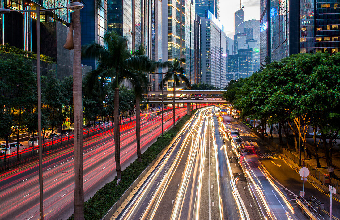 Hongkong, China. Downtown Verkehr in Gloucester Road in der Nacht mit Autos streifen auf der Straße mit Wolkenkratzern an den Seiten des Central Hong Kong District